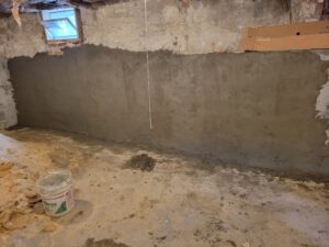 parging (cement) freshly applied to the interior of a basement wall