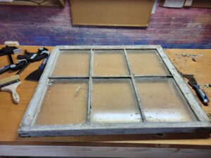 an old wooden window on a workbench